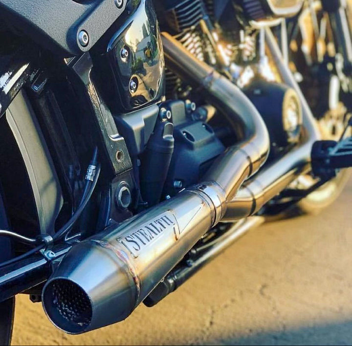 Stealth Pipes exhaust system installed on Harley M8 Softail – rear-side view of muffler and headers (2017–2025)