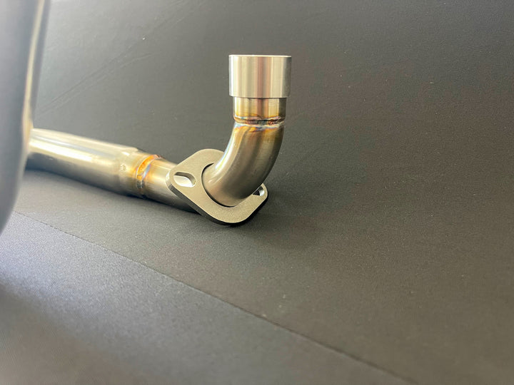 Honda Monkey with Stealth x Kruesi Originals exhaust system – rear angle showing stainless muffler