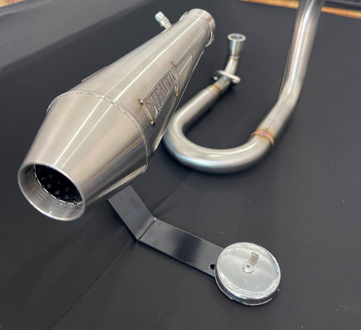 Close-up of Stealth x Kruesi Originals cone-style muffler for Honda Monkey exhaust system
