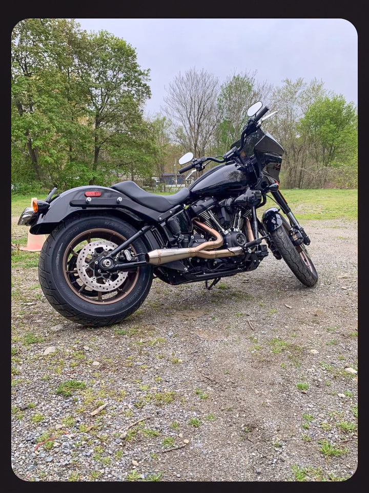 Stealth Pipes exhaust system installed on Harley M8 Softail – rear-side view of muffler and headers (2017–2025)