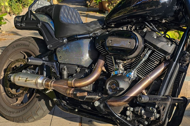 Stealth Pipes exhaust system installed on Harley M8 Softail – rear-side view of muffler and headers (2017–2025)