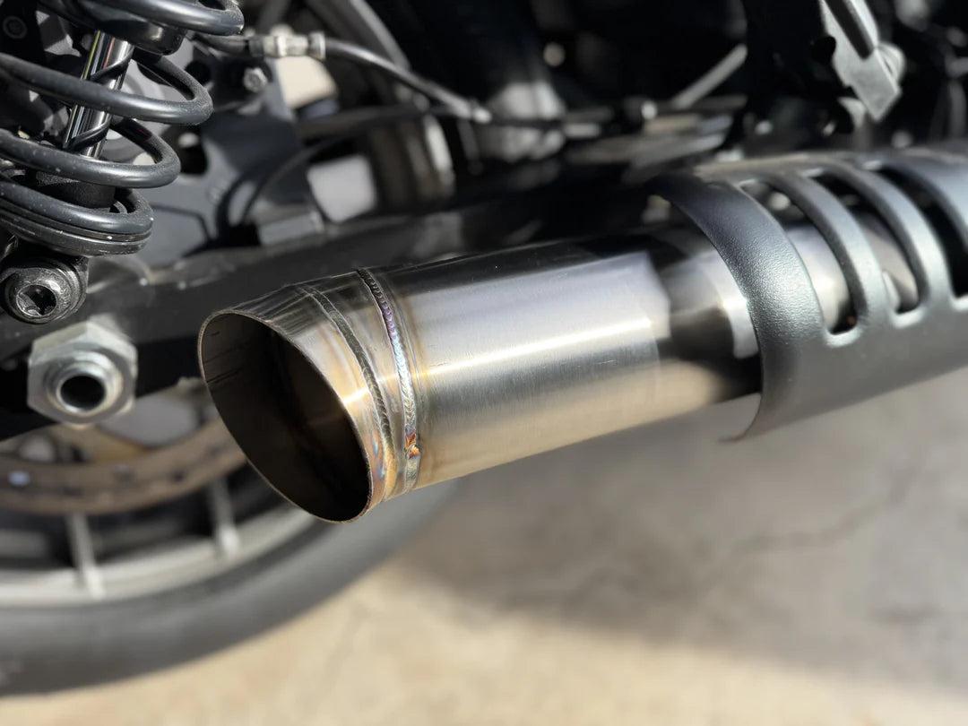 Close up of slip-on muffler exhaust system for a Harley Davidson Nightster, made of stainless steel, installed on a motorcycle