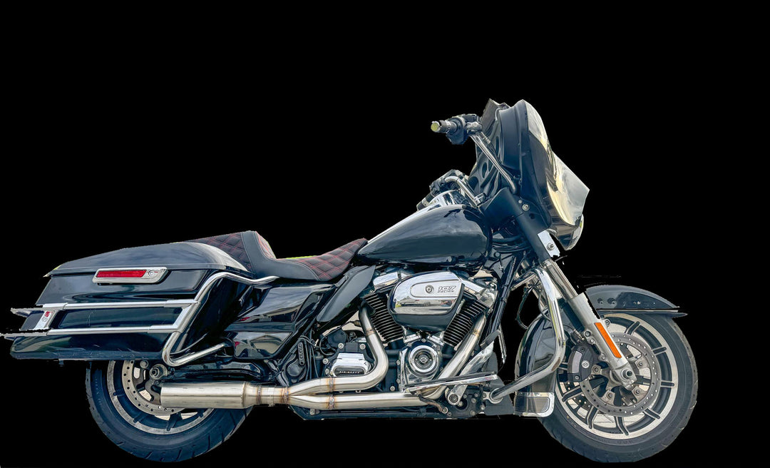 A black motorcycle with a custom exhaust breacher system.