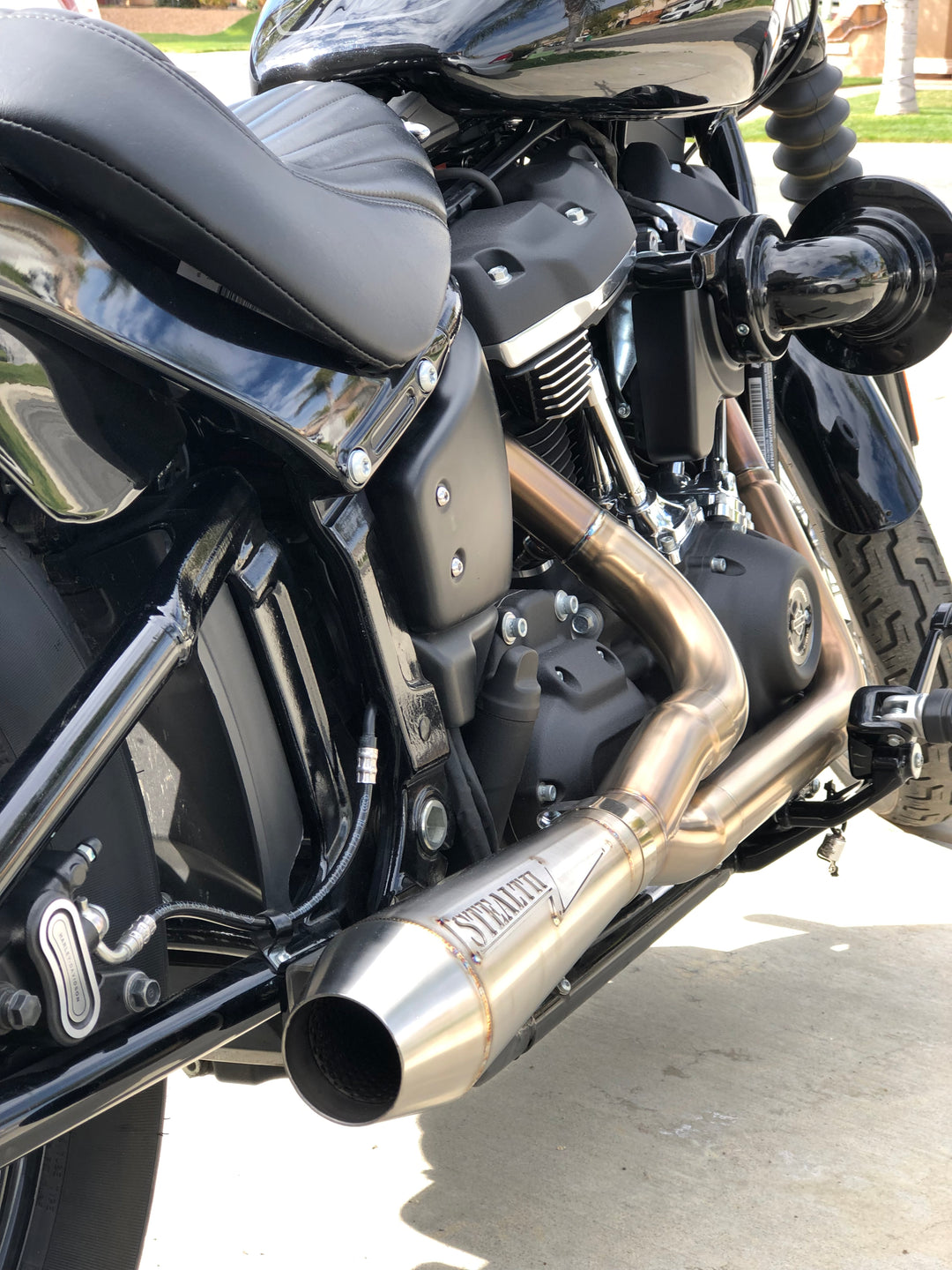 Harley M8 Softail motorcycle with Stealth Pipes exhaust – riding photo, stainless muffler upgrade for 2017–2025 models