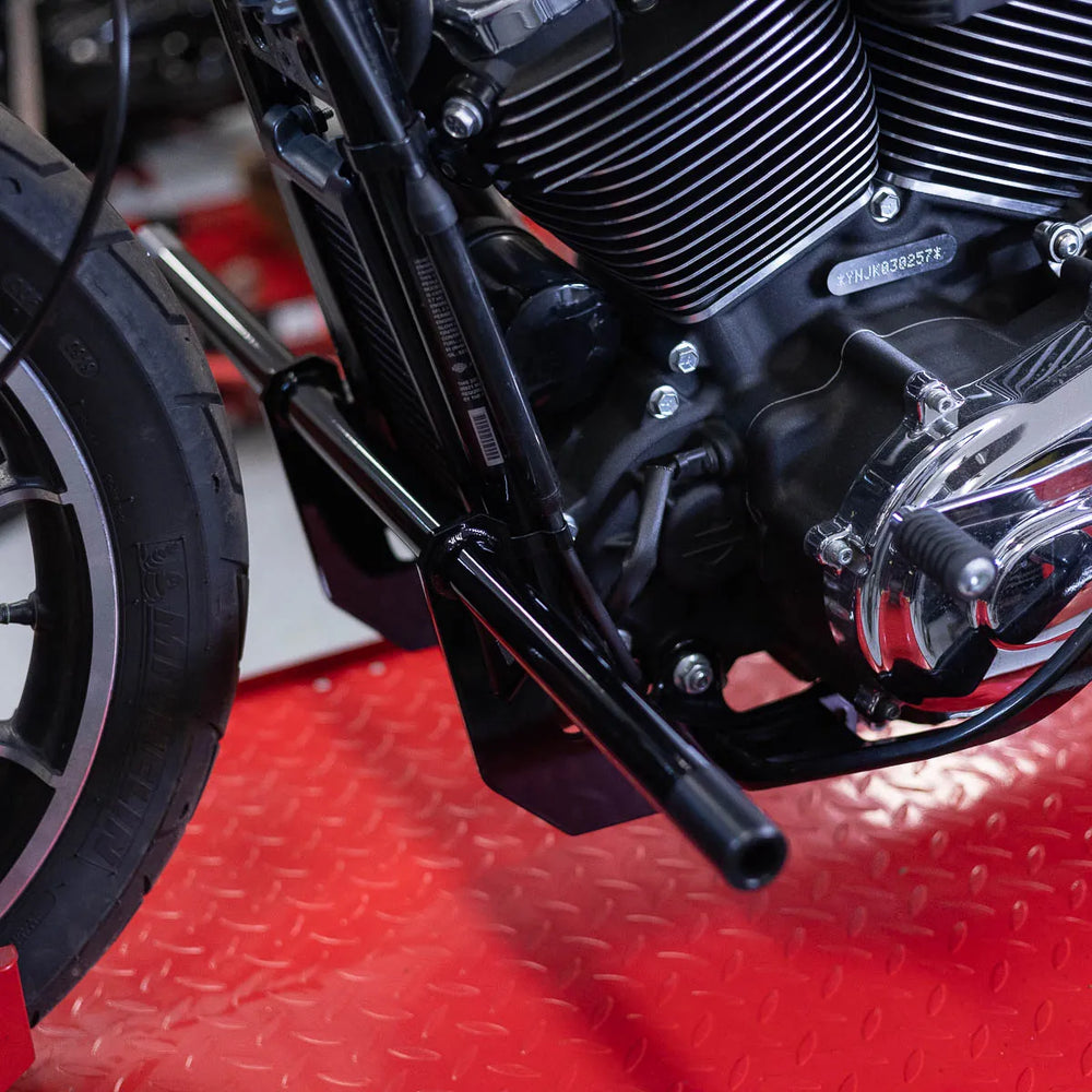 A black Softail Front Crash Bar designed for motorcycles, displayed installed on motorcycle.