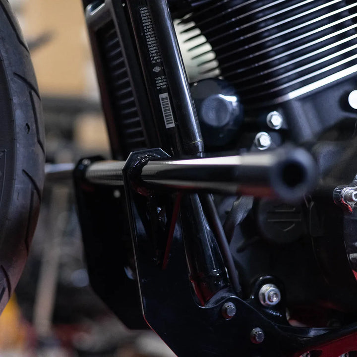 A black Softail Front Crash Bar designed for motorcycles, displayed installed on motorcycle.