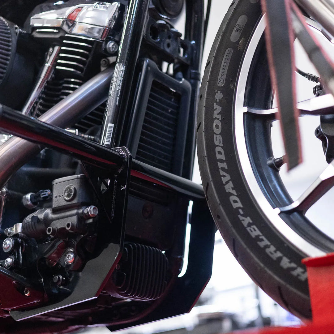 A black Softail Front Crash Bar designed for motorcycles, displayed installed on motorcycle.