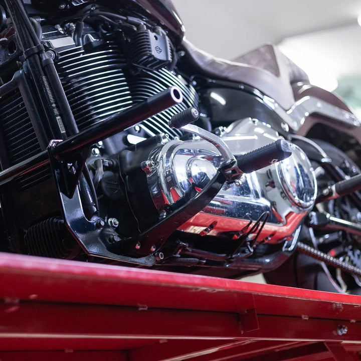 A black Softail Front Crash Bar designed for motorcycles, displayed installed on motorcycle.
