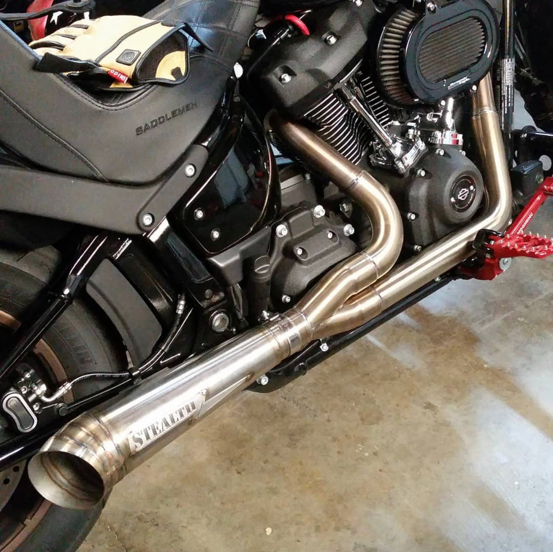 Stealth Pipes exhaust system installed on Harley M8 Softail – rear-side view of muffler and headers (2017–2025)