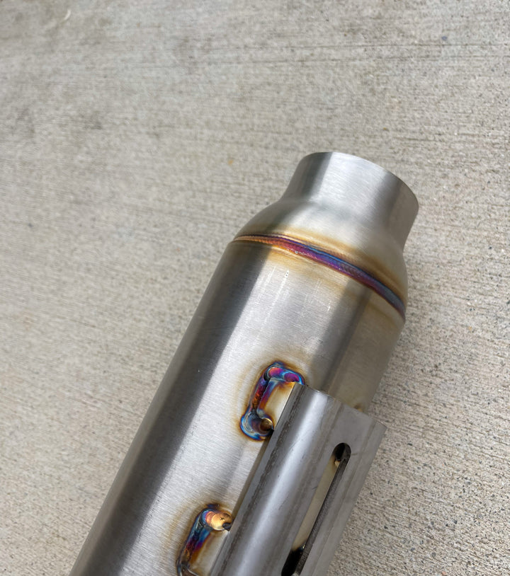 Close-up of Stealth Pipes Pipe Bomb Muffler – stainless TIG welds and engraved logo