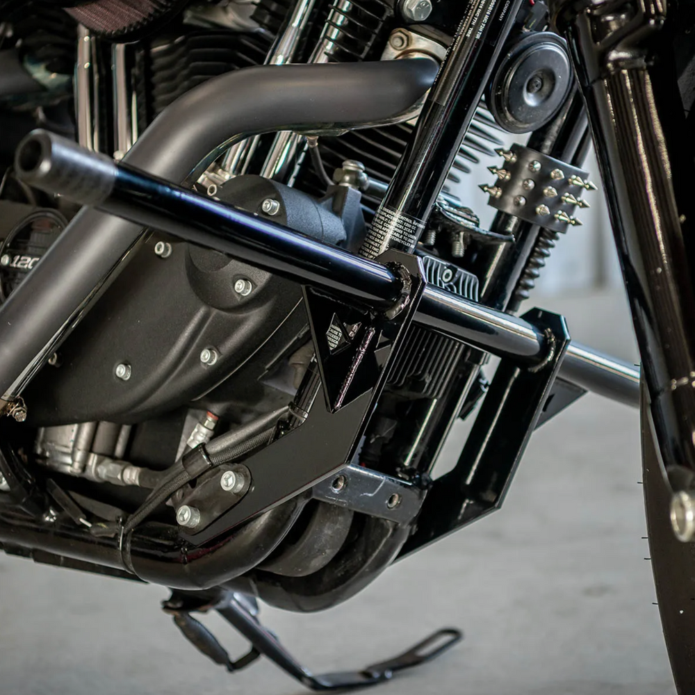 A black front crash bar installed on a Harley Davidson Sportster motorcycle