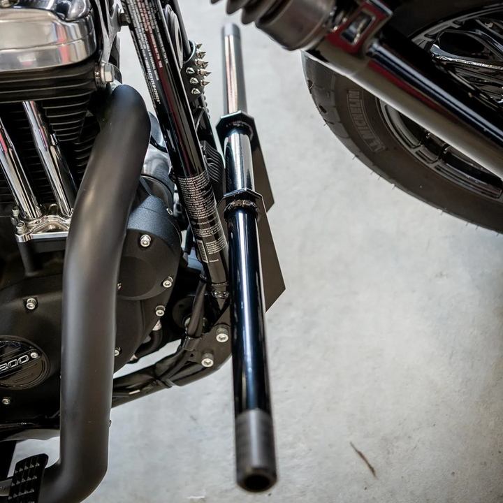 A black front crash bar installed on a Harley Davidson Sportster motorcycle