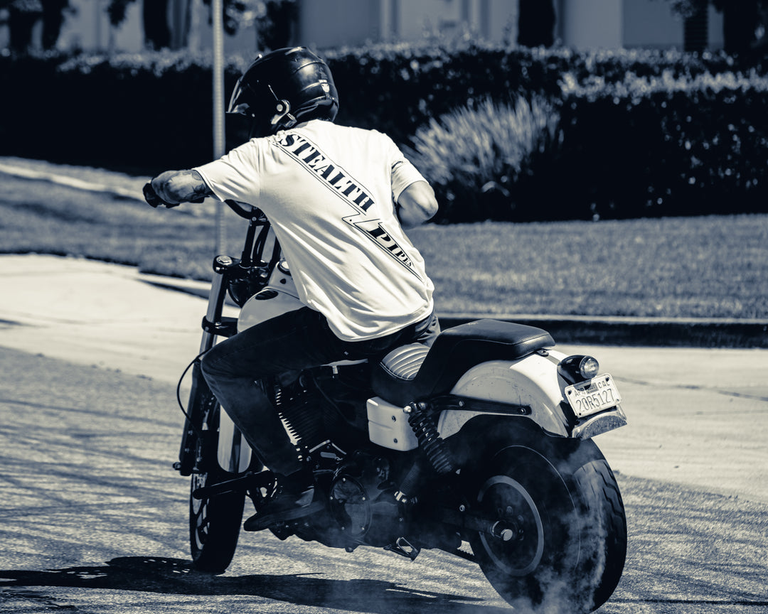 Side view of rider wearing Stealth Rider T-shirt while riding Harley motorcycle